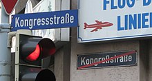 This street sign in Aachen shows a very rare example of a name being changed after the orthography reform of 1996. Spellings in names were, in almost all cases, not changed. Note the old version on the wall. RechtschreibreformBeiStrassennamen.jpg