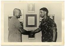 Robert Mueller wearing an ERDL-patterned uniform in 1969. Robert Mueller receives award from Martin Sexton in South Vietnam in 1969.jpg