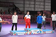 Deutsch: Tischtennis bei den Olympischen Jugend-Sommerspielen 2018: Tag 4, 10. Oktober 2018, Jungen-Einzel, Siegerehrung - Gold: Wang Chuqin (CHN), Silber: Tomokazu Harimoto (JPN), Bronze: Kanak Jha (USA); Medaillen überreicht durch IOC-Mitglied William Frederick Blick (UGA), Maskottchen überreicht durch ITTF-Präsident Thomas Weickert (GER) English: Fencing at the 2018 Summer Youth Olympics at 10 October 2018 –Boys' single medail ceremony – Gold: Wang Chuqin (CHN), Silber: Tomokazu Harimoto (JPN), Bronze: Kanak Jha (USA)); Medal presenter: IOC member William Frederick Blick (UGA), Mascot presenter: ITTF President Thomas Weickert (GER)