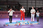 Deutsch: Tischtennis bei den Olympischen Jugend-Sommerspielen 2018: Tag 4, 10. Oktober 2018, Mädchen-Einzel, Siegerehrung - Gold: Yingsha Sun (CHN), Silber: Miu Hirano (JPN), Bronze:Andreea Dragoman (ROU)); Medaillen überreicht durch IOC-Mitglied Ching-kuo Wu (TPE), Maskottchen überreicht durch ITTF-Vize-Präsident Masahiro Maehara (JPN) English: Fencing at the 2018 Summer Youth Olympics at 10 October 2018 – Girls' single medail ceremony – Gold: Yingsha Sun (CHN), Silber: Miu Hirano (JPN), Bronze:Andreea Dragoman (ROU)); Medal presenter: IOC member Ching-kuo Wu (TPE), Mascot presenter: Vice-President Executive of the ITTF Masahiro Maehara (JPN)