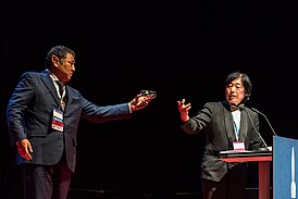 Takeshi Ikeda handling the Seiun Award prize to Takayuki Tatsumi, at the Hugo Awards Ceremony 2017 at Worldcon in Helsinki.jpg