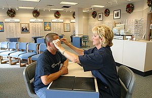 A US Navy optician adjusting a customer's glasses US Navy 021029-N-3228G-001 Adjusting a customer's eyeglasses.jpg