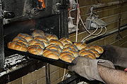 9. Freshly baked rolls are removed from the oven.