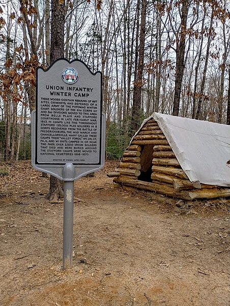 Marker and recreated winter hut at the site of the XI Corps winter encampment in Stafford Civil War Park, Virginia, February 2024.