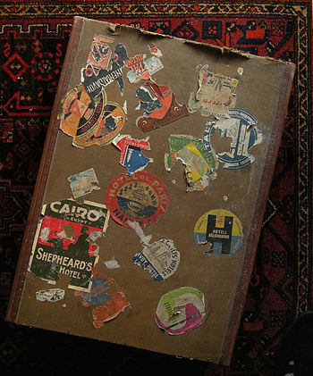 A suitcase covered in luggage tags, which were placed on customers' suitcases by hotels from the 1900s to the 1960s as a promotional tactic.