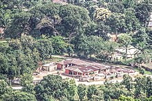 Labesta Guess Inn from the Afan Agworok mountaintop. A BUILDING SURROUNDED BY TREES.jpg