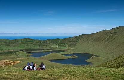 A couple enjoys the views of Caldeirão, Corvo Island, Azores, Portugal