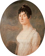 Formal portrait, half length, of a young, dark haired woman; her hair is plaited around her head, with curls framing her face. She is wearing a diaphanous shawl around her shoulders, over a short-sleeved gown which shows a great deal of decolletage.