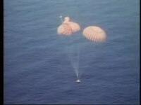 A spacecraft descends to the ocean