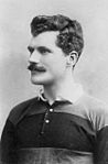 Arthur Gould wearing the black and amber hooped shirt of Newport RFC