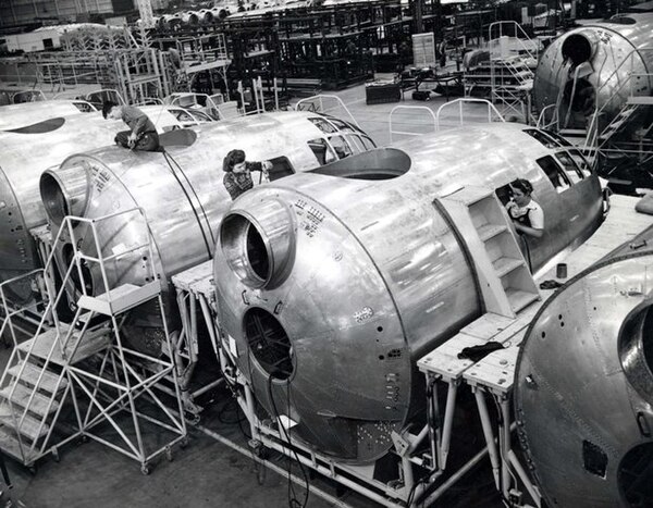 Workers assemble the forward compartment of a B-29 at the Boeing plant in Seattle, Washington