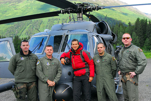 Grylls in front of an Alaska Air National Guard helicopter before heading out to Spencer Glacier to film Man vs. Wild
