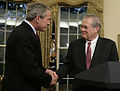 Rumsfeld shakes President Bush's hand as he announces his resignation