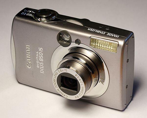 A point-and-shoot digital camera with optical viewfinder made by Canon, specifically the IXUS 850 IS, early 2010s