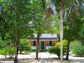 Restored traditional house and sand garden in the Queen Elizabeth II Botanic Park Caymanian home botanical park.jpg