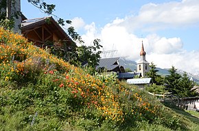 Colourfull flowers at the mountain village Les Chapelles with its church - panoramio.jpg
