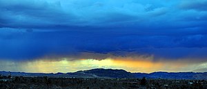 A sunshower over Crater Mountain, Landers, California Crater Mountain Panarama.jpg