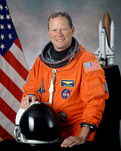 David M. Brown, NASA photo portrait in orange suit.jpg