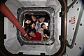 The six-member Expedition 59 crew poses for a portrait looking through the vestibule between Node 1 (Unity) and Northrop Grumman's Cygnus commercial space freighter. The closeout covers a full complement of rotated CPAs.[6][35]