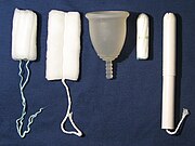 A large Fleurcup menstrual cup (center) can hold about three times as much liquid as a large tampon. Fleurcup and tampons.jpg