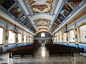 Church nave from the sanctuary showing the ceiling paintings