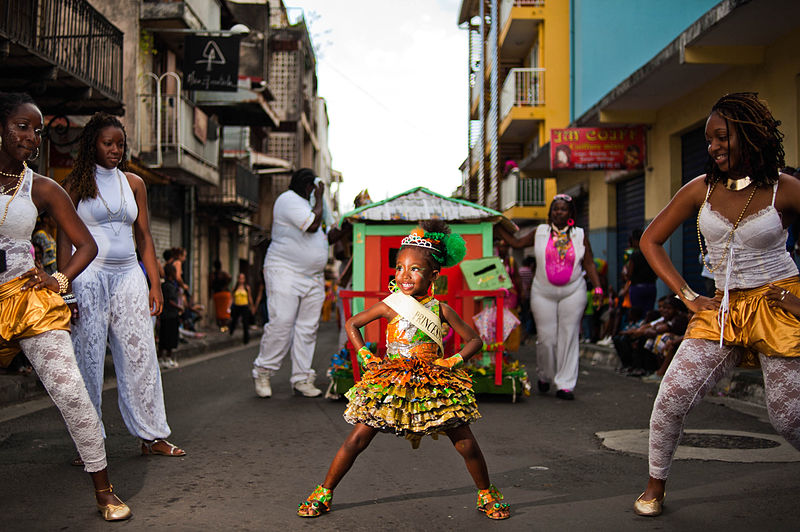 File:Guadeloupe winter carnival, Pointe-à-Pitre parade. A little girl performing a dance during parade (full length outdoor portrait).jpg