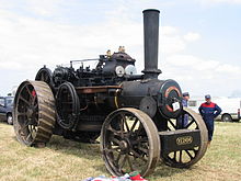 A John Fowler & Co. Ploughing Engine - the winding drum is mounted below the boiler (the 'drum' on the side is actually a hose for refilling the water tank). A lockable tool box may be seen on the front axle; the 'spud tray' would be mounted in the same way, behind the axle. JohnFowlerTractionEngine.JPG