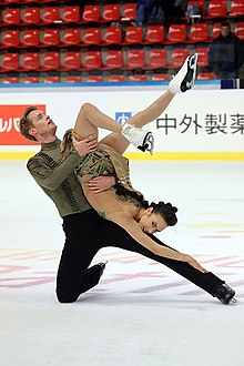 Evan Bates, shown here performing with Madison Chock, holds the record for the most total medals won by a skater in ice dance (eight). Madison Chock and Evan Bates - 2019 Internationaux de France.jpg