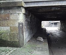 Grooves worn by ropes of canal barges at Townhead on the Cut of Junction, now pedestrian subway under Castle Street at Royston Road Old rope marks Glasgow.jpg