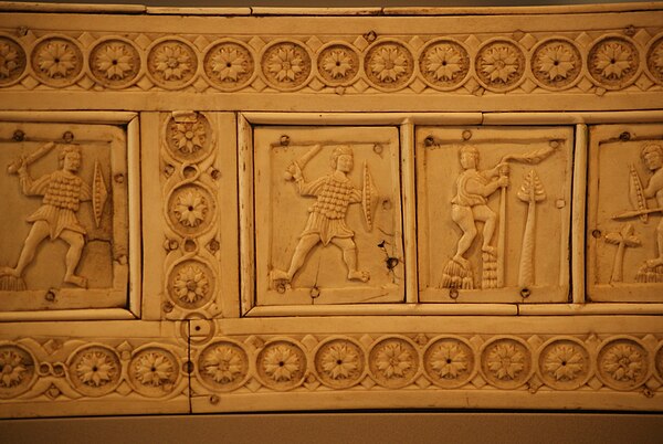 A 10th–12th century ivory relief of a Byzantine swordsman wearing scale armor and round shield– Berlin Bode museum.