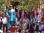 Petry - seated to his left, Santa Fe mayor David Coss, New Mexico Governor Susana Martinez, and sculptor and governor of Pojoaque Pueblo, George Rivera. Sgt. Leroy Perty and statue.jpg