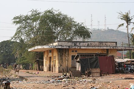 The then-derelict Sisophon railway station before renovation, with the watchtower on Phnom Bak, behind.