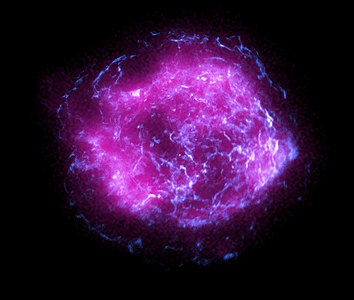 Image of the supernova Cassiopeia A combining some of the first X-ray data collected by IXPE, shown in magenta, with high-energy X-ray data from Chandra X-Ray Observatory in blue