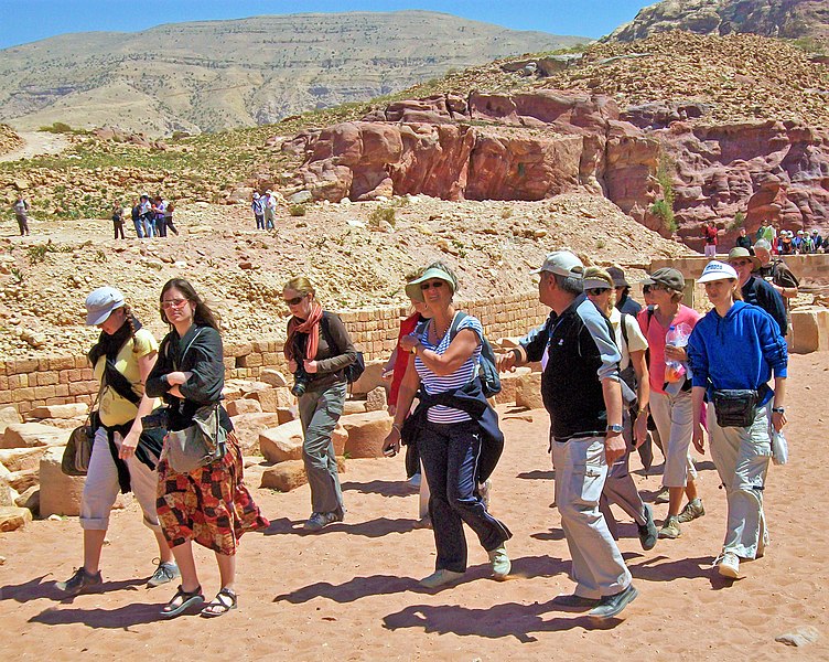 File:Tourists with guide in lower canyon, Petra.jpg