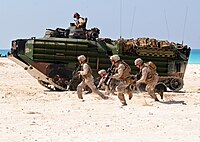 U.S. Marines with India Company, Battalion Landing Team, 3rd Battalion, 2nd Marine Regiment, 22nd Marine Expeditionary Unit run on the beach during an amphibious assault demonstration.jpg