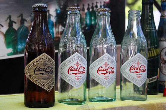 Four old Coca-Cola bottles.