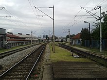 The view to the west from Strojarska Road overpass. The crash site is located about 300 m (980 ft) away, 150 m (490 ft) behind the carriages in the centre of the picture. View to the west from the overpass Strojarska street.jpg