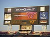 A jumbotron surrounded by various ads congratulating Virginia Tech on the victory.