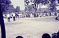 ASC Leiden - Rietveld Collection - Nigeria 1970 - 1973 - 01 - 059 Sallah festivities in Bauchi. A crowd in white, order keepers in red and green in front of a mosque with dome and minaret, two agents in white.jpg