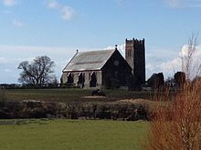 St Andrew's Church, Andreas. The tower was reduced on the request of the Air Ministry as it was seen as a danger to operations from the base. Andreas Church (reduced tower).jpeg