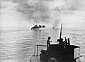 HMAS Australia and HMAS Arunta bombarding Cape Gloucester viewed from HMAS Shropshire on 26 December 1943