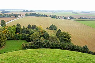 A view of the battlefield from the Lion's Mound. At the top right are the buildings of La Haye Sainte. Belgium-6773 - Battlefield View (14152126362).jpg