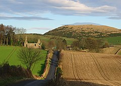 Ruins of the old parish church;  Brunton is largely obscured by trees