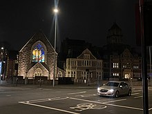 The former chapel's stained glass window. The Chapel is now the home of Adamsdown Library CRI at Night.jpg