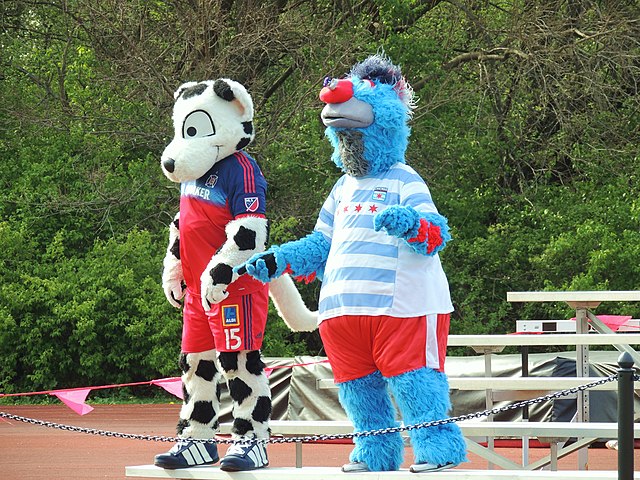 Chicago Fire mascot Sparky at a Red Stars game with Supernova, the Red Stars mascot