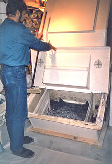 Composting container of "TerraNova" composting toilet, showing open removal chamber (town house at the ecological settlement Hamburg-Allermohe, Germany) Composting container "TerraNova", showing open removal chamber (6210814073).jpg