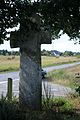 Croix en laiton à Guillac, Morbihan.
