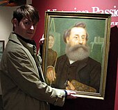 Christian Corbet holding a self-portrait of Denys Corbet Coll. Guernsey Museum and Gallery, 2006