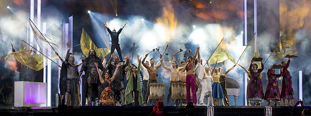 Mede and Måns Zelmerlöw (center right) performing the interval act "Love Love Peace Peace" in the final of the Eurovision Song Contest 2016.