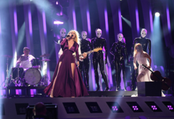 The Humans (pictured) performing during a rehearsal. Their performance featured several black and white, masked mannequins, representing the depersonalization and the loss of identity in modern society. ESC2018 - Romania 02 (cropped).png